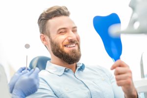 man smiling at dentist