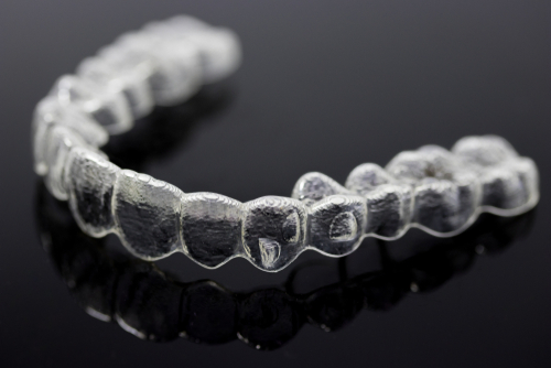 Invisalign braces or invisible retainer isolated on black background-img-blog