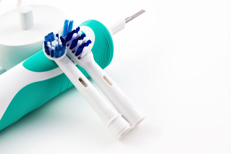 Electric toothbrush with two attachments